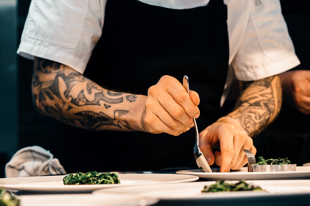A chef carefully plating a dish on the line
